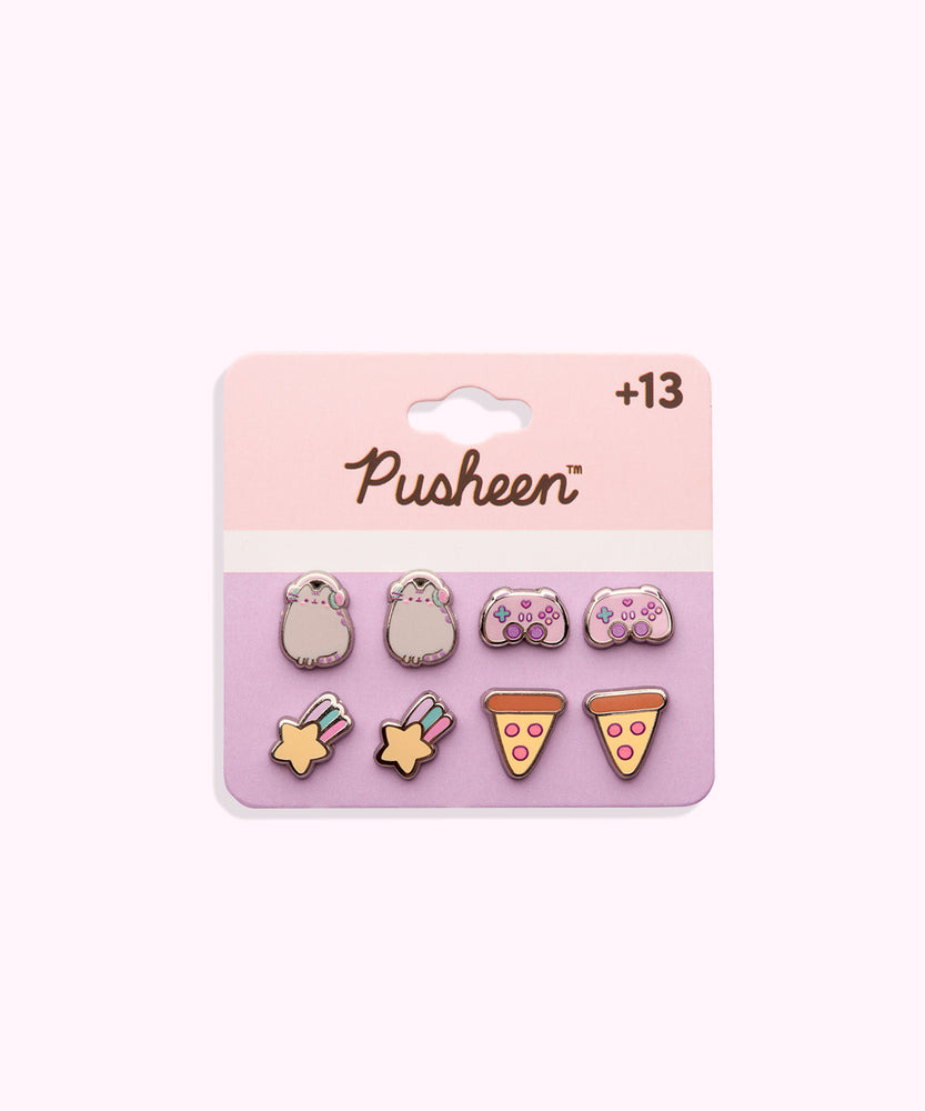 Gaming Pusheen 4-Pack Stud Earrings Set on their cardboard backing card. The top half of the card has the Pusheen logo in brown on a light pink background and the bottom half of the card is purple. 