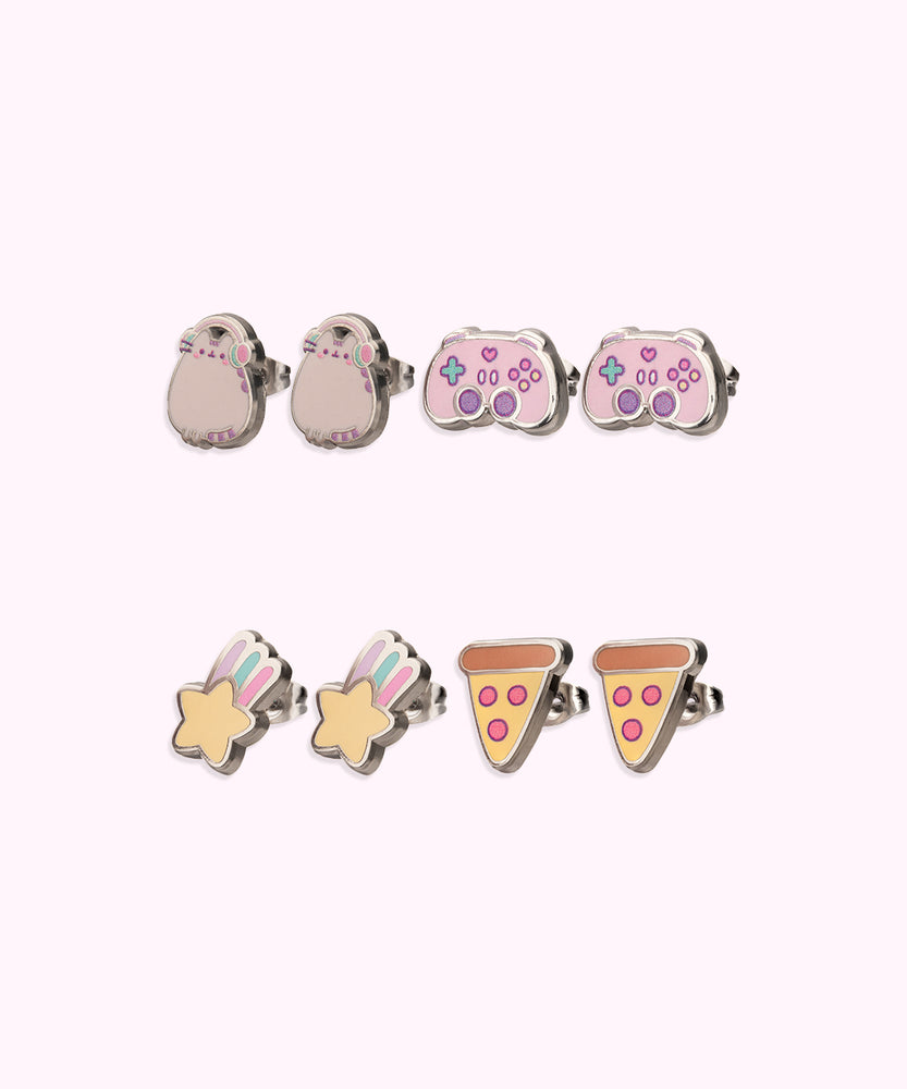 Earrings in the Stud Set turned to the side to show the shine of the outline of the stainless-steel edging. The set includes Pusheen wearing pink and mint green headphones, a pink and purple gaming controller, a yellow shooting star with purple, green, and pink streaks, and a yellow cheese pizza with a brown crust and pink pepperonis.  