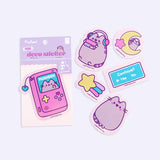 View of all the stickers included in the Gaming Pusheen Phone Stickers pack. The stickers feature various graphics of Pusheen the Cat gaming and some classic gamer icons. 