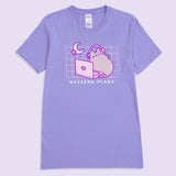 A purple graphic t-shirt lies against a light purple background. The unisex tee shirt has a screen-printed graphic in the center of the chest showing Pusheen the Cat with headphones on sitting in front of a laptop. 