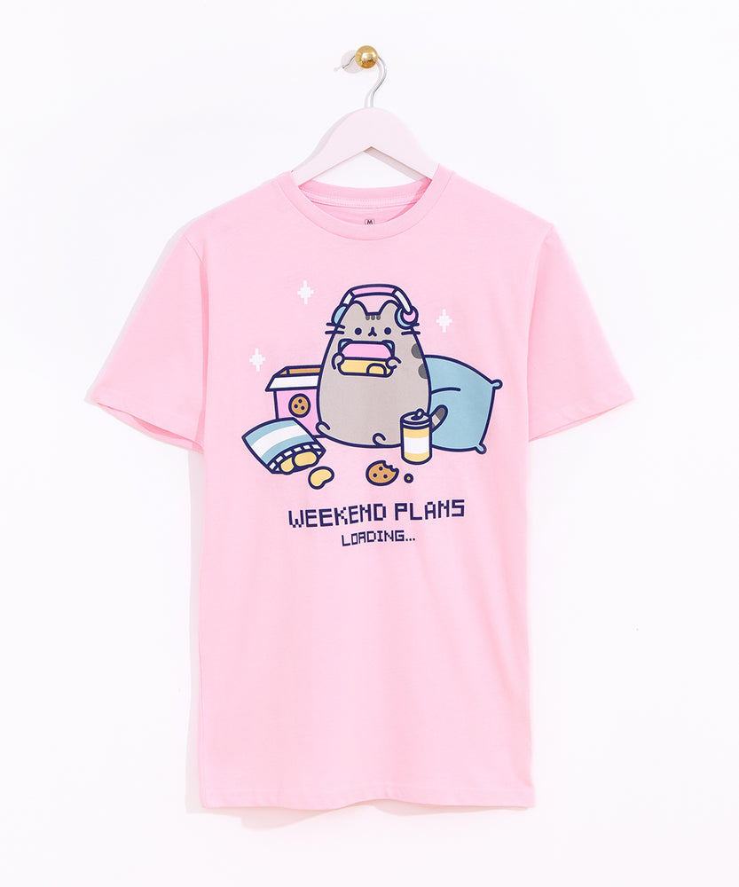 Gaming Pusheen Tee hangs on a light pink hanger in front of a white background. The graphic tee has a large print in the center of the t-shirt. 