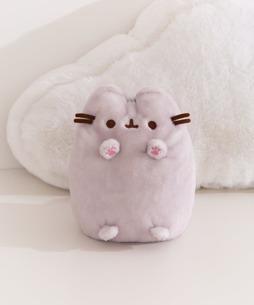 Gray Dreamsheen Pusheen plush with 3D paws with pink embroidered toe beans, brown facial features, and 3D whiskers.