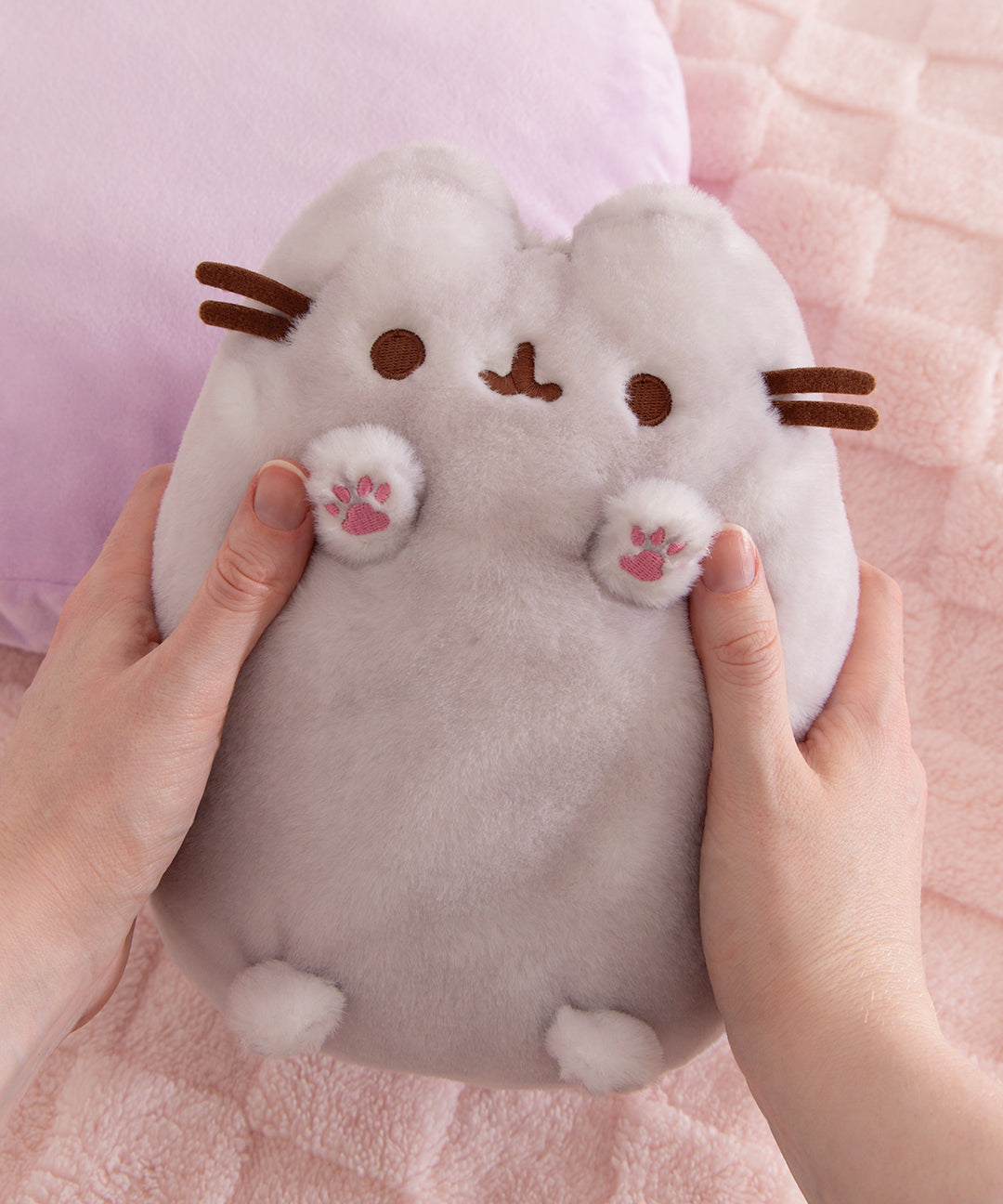 Model hold the fluffy Gray Pusheen Dreamsheen plush to show size and scale of plush toy.