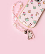 Beaded phone charm is attached to the intended slot in the bottom right corner of the back of the Pusheen phone case. 