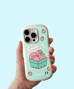 Model holds Pusheen Fruits Phone Case. The mint green case has rounded rubber edges for bump protection. The mint green case has a graphic of Pusheen the Cat sitting in a strawberry carton with the phrase "Sweet" above it.