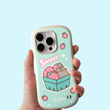 Model holds Pusheen Fruits Phone Case. The mint green case has rounded rubber edges for bump protection. The mint green case has a graphic of Pusheen the Cat sitting in a strawberry carton with the phrase "Sweet" above it.