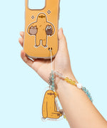 Sloth Phone Charm is attached to a Sloth Phone Case. The beaded string is inserted in the intended slot at the bottom right of the phone case.  
