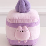 Close-up of the Pusheen figure within the plush cake and cream layers. Pusheen the Cat's two front paws sit outside of the cream layer.