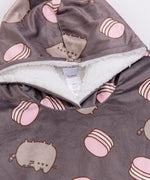 A close-up view of the hoodie hood interior. The white sherpa fabric accented the white details in the all-over-print of the pink and white macarons.  