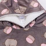 A close-up view of the hoodie hood interior. The white sherpa fabric accented the white details in the all-over-print of the pink and white macarons.  