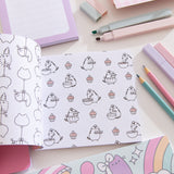 Mini Pusheen Coloring & Activity Book is opened to two white coloring pages with black graphics. On the left page is a repeating pattern of Stormy & Pip being carried by balloons. On the righthand page is a repeating pattern of Pusheen the Cat baking with cupcakes.