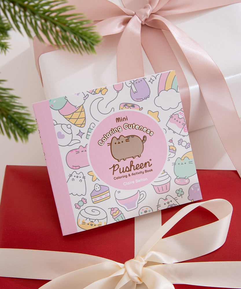 Back cover of the Mini Coloring Cuteness: A Pusheen Coloring & Activity Book. The white-colored background has a pattern of pastel graphics of Pusheen climbing an ice cream cone, Pusheen as a ghost, Pusheen as a strawberry milk carton, a teapot, candy, and more. The book has a light pink spine. Print on the bottom of the cover is the publisher, a UPC code, and pricing information.