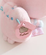 Close-up of the Pusheen Label hang tags that are attached to the side of the bag charm.