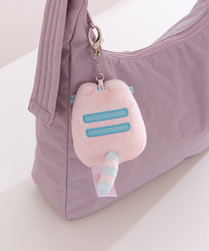 Back view of Pink Dreamsheen Bag Charm. On the back of the plush keychain is two embroidered horizontal stripes.