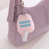 Back view of Pink Dreamsheen Bag Charm. On the back of the plush keychain is two embroidered horizontal stripes.