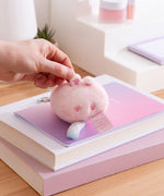 Small pink Dreamsheen plush bag charm with paw print details on the bottom. 