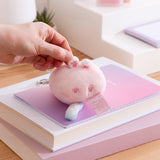 Small pink Dreamsheen plush bag charm with paw print details on the bottom. 