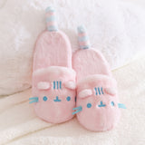 Pair of Pink Dreamsheen Plush Slippers with blue accents on a soft white background.