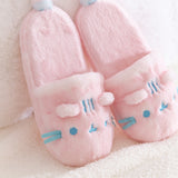 Close-up of the ears and face embroidery details on the Pink Dreamsheen Plush Slippers. 