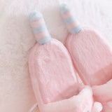 Close-up of the light pink and blue striped tails that extend off the back of the plush Pusheen slippers.