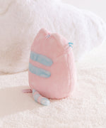 Back view of the pink plush with light blue accents. The fabric on the plush is two-toned.