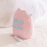 Back view of the pink plush with light blue accents. The fabric on the plush is two-toned.