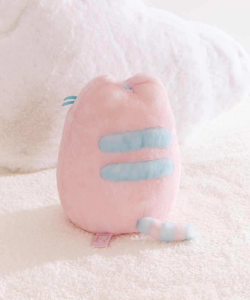 Back view of the plush toy with light blue detailing on back and tail. 