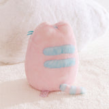 Back view of the plush toy with light blue detailing on back and tail. 