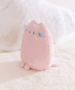 Quarter side view of the Pink Dreamsheen Plush. The 9" tall plush has two front paws that extend off the bottom front of the plush. 