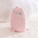Quarter side view of the Pink Dreamsheen Plush. The 9" tall plush has two front paws that extend off the bottom front of the plush. 
