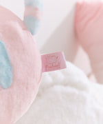 Close-up of the Pusheen Shop logo tag that is attached to the back bottom of the plush.
