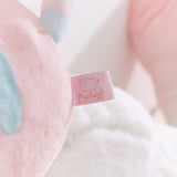 Close-up of the Pusheen Shop logo tag that is attached to the back bottom of the plush.