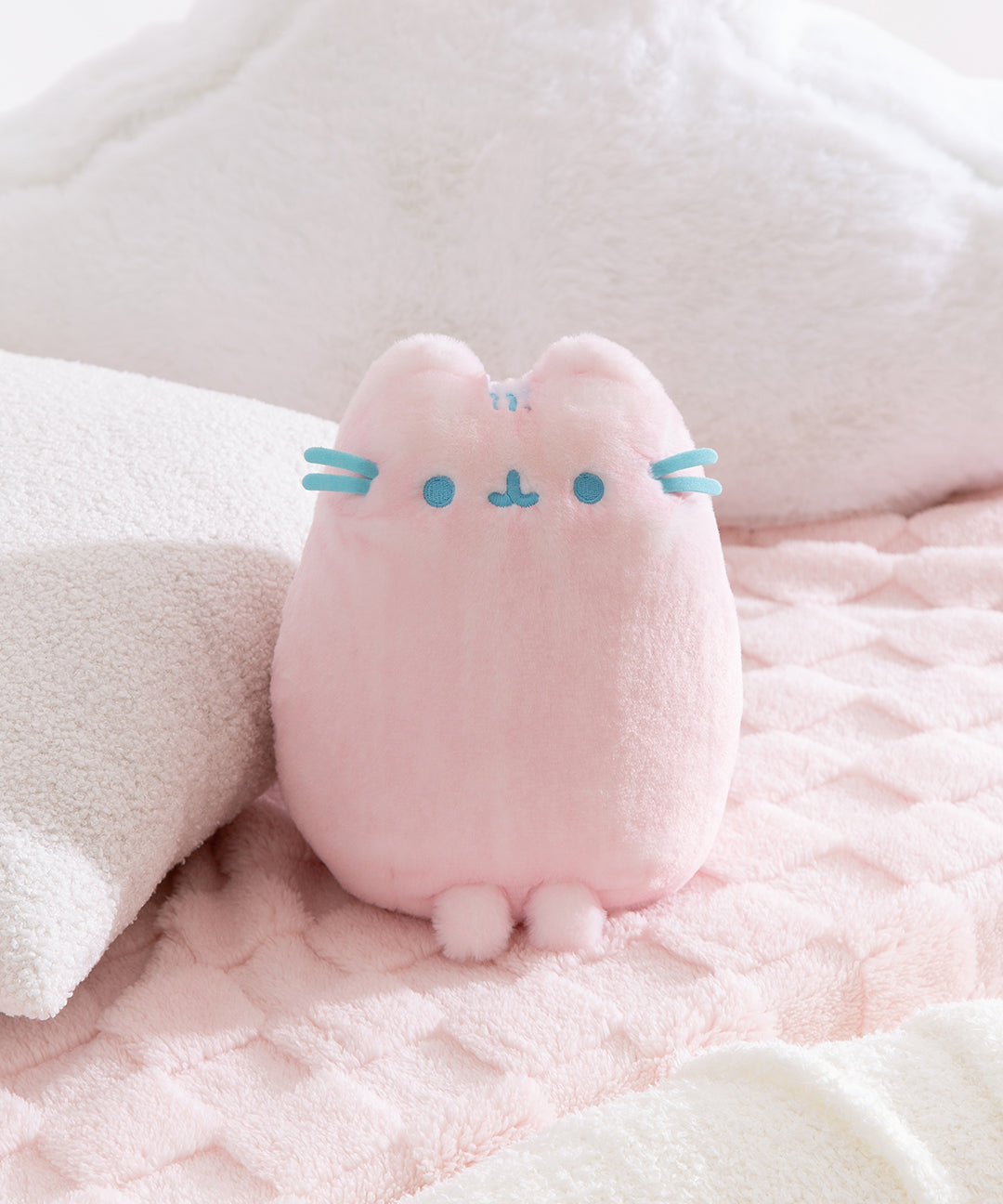 Pink Dreamsheen Plush cat toy with blue accents on a soft pink background.