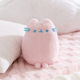 Pink Dreamsheen Plush cat toy with blue accents on a soft pink background.