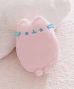 Pink plush toy with blue accents on a soft beige background.