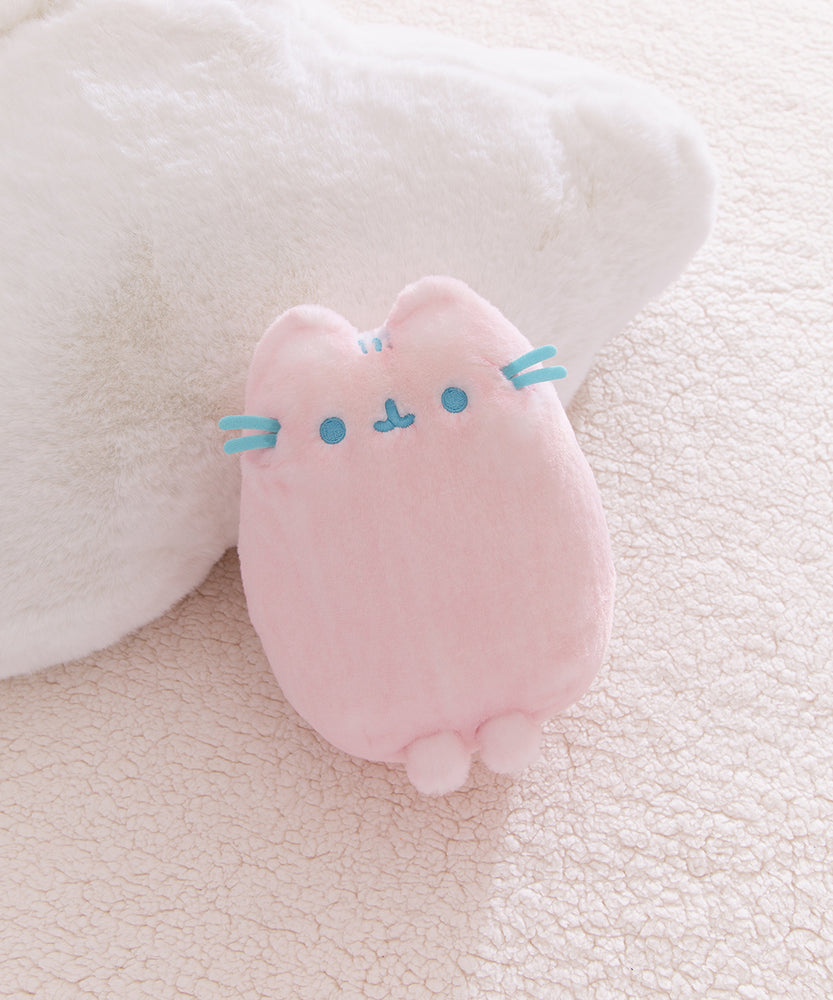 Pink plush toy with blue accents and front paws extending off the bottom of the plush.