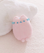 Pink plush toy with blue accents and front paws extending off the bottom of the plush.