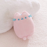 Pink plush toy with blue accents and front paws extending off the bottom of the plush.