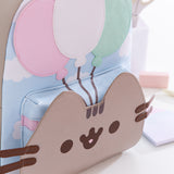 Close-up of the smiling cat face and balloons trio on the very front of the 15th Anniversary Backpack. Pusheen's face hides the access to the front pocket. 