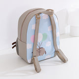 Full view of the back of the anniversary backpack. The pack has a top handle and adjustable grey straps that matches the color of the top of the backpack. 