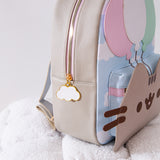 Close-up side view of the backpack. The gold and pink zipper has a white cloud zipper charm pull outlined in gold. 