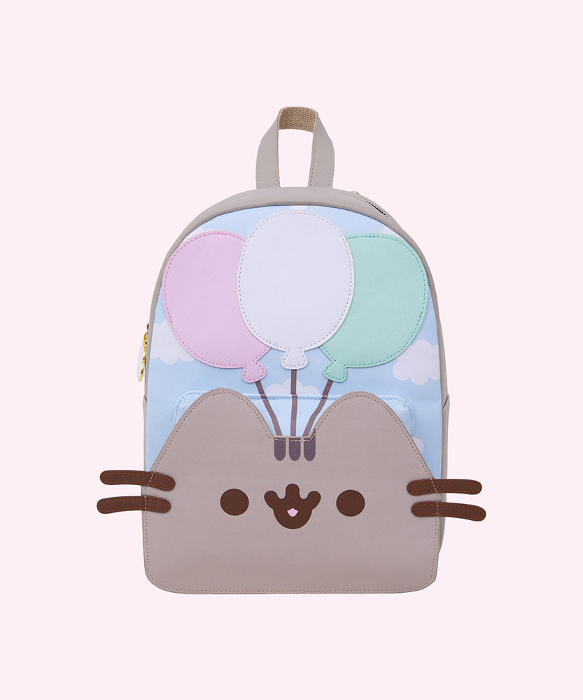 Full front view of the Pusheen backpack. Pusheen's brown whiskers are 3D and extend off the sides of the backpack. 