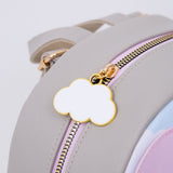 Close-up of the gold and white cloud zipper pull on the grey cat backpack. 