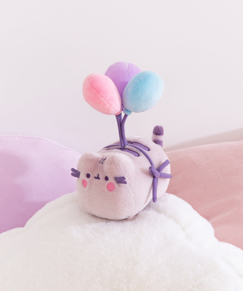 Pusheen 15th Anniversary Plush sits atop a cloud pillow. 