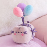 Plush toy with pastel-colored balloons on a soft surface