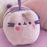 Plush toy with a embroidered face design on a pink background
