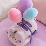 Close-up of the three multi-colored balloons on the 15th Anniversary Pusheen Plush.