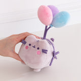 Pusheen plush toy with balloons held by a hand on a white background
