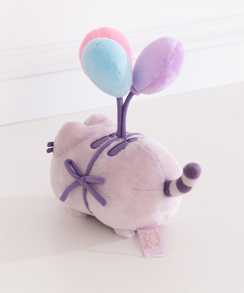 Back view of the anniversary plush toy showing Pusheen's purple and light grey striped tail.