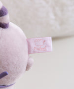 Close-up of the white and pink Pusheen Shop tag attached to the bottom of the plush.